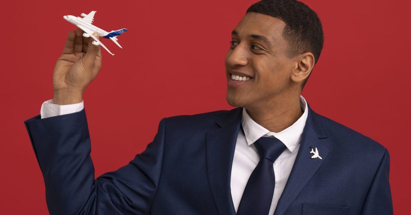 portrait-flight-attendant-with-plane-figurine